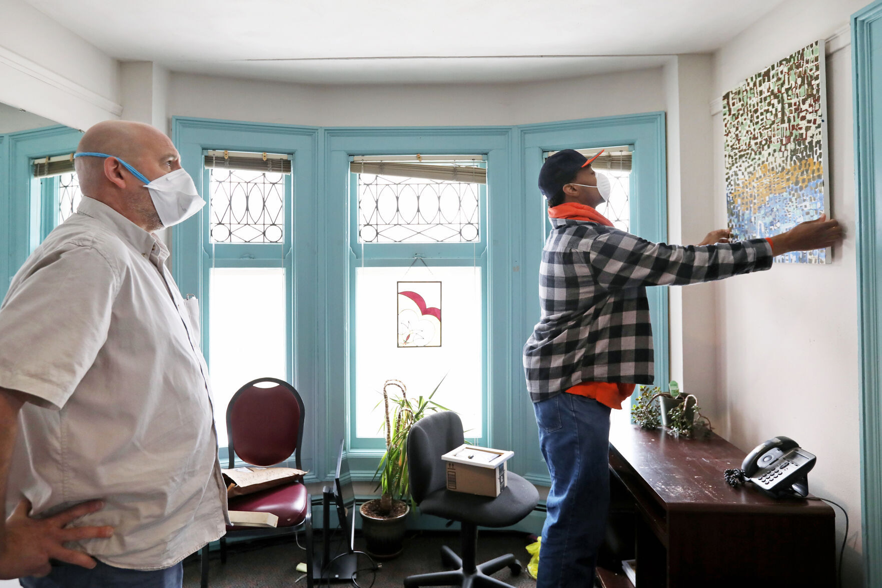 Hanging Scott Hansen's artwork at Yahara House